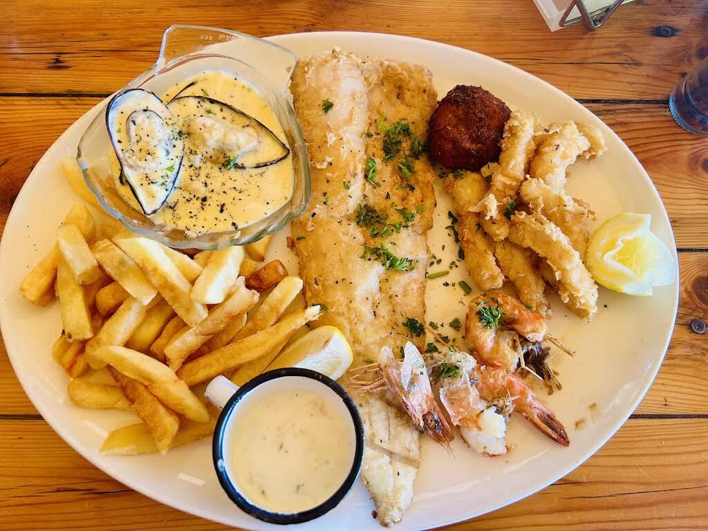 Seafood platter with hake, prawns, calamari, mussels and chips